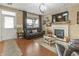 Cozy living room featuring fireplace, hardwood floors, and comfortable seating at 236 N Liberty Blvd, Mooresville, IN 46158