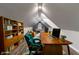 Bright attic office features a wood desk, comfortable chair, and built-in shelving at 236 N Liberty Blvd, Mooresville, IN 46158