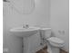 Clean bathroom with pedestal sink and toilet at 10612 Maidenhair Dr, Indianapolis, IN 46239