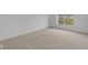 Carpeted bedroom with a window overlooking the backyard at 10612 Maidenhair Dr, Indianapolis, IN 46239