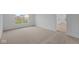 Bright bedroom featuring carpeted floors and a large window at 10612 Maidenhair Dr, Indianapolis, IN 46239