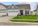 Ranch home with gray siding, white trim, and a two-car garage at 10612 Maidenhair Dr, Indianapolis, IN 46239