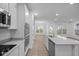 Modern kitchen with white cabinets, stainless steel appliances and an island at 10612 Maidenhair Dr, Indianapolis, IN 46239