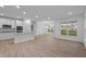 Open concept kitchen with white cabinets, stainless steel appliances, and an island at 10612 Maidenhair Dr, Indianapolis, IN 46239