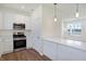 Modern kitchen with stainless steel appliances and white cabinets at 3895 Wren Dr, Brownsburg, IN 46112