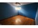 Bright blue bedroom with hardwood floors and a window at 2620 Wicker Rd, Indianapolis, IN 46217