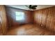 Bedroom with wood paneled walls and hardwood floors at 2620 Wicker Rd, Indianapolis, IN 46217