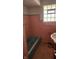 Pink tiled bathroom with a bathtub and a window at 2620 Wicker Rd, Indianapolis, IN 46217