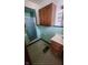 Bathroom with teal tile and wood cabinets at 2620 Wicker Rd, Indianapolis, IN 46217