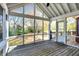 Spacious screened porch with wood floors and views of the autumn foliage at 6640 Greenridge Dr, Indianapolis, IN 46278