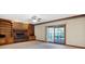 Bright living room with fireplace, built-in shelves, and sliding glass doors to a deck at 6640 Greenridge Dr, Indianapolis, IN 46278