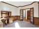 Home office with wood-paneled walls, built-in desk and shelving at 6640 Greenridge Dr, Indianapolis, IN 46278