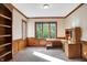 Bright home office with wood built-ins and large window overlooking trees at 6640 Greenridge Dr, Indianapolis, IN 46278