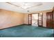 Spacious bedroom with teal carpet, neutral walls, and ceiling fan at 6640 Greenridge Dr, Indianapolis, IN 46278