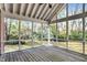 Bright screened porch with wooden floors and serene backyard view at 6640 Greenridge Dr, Indianapolis, IN 46278