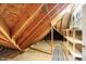 Unfinished attic space with wooden beams and shelving at 6640 Greenridge Dr, Indianapolis, IN 46278