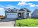 Two-story house with gray siding and stone accents at 7171 Rose Hill Ave, Brownsburg, IN 46112