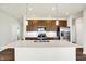 Kitchen with a large island, stainless steel appliances, and wood cabinets at 7171 Rose Hill Ave, Brownsburg, IN 46112