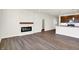Living room with fireplace, wood-look floors, and an open concept at 7171 Rose Hill Ave, Brownsburg, IN 46112