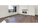 Living room with fireplace, large window, and wood-look floors at 7171 Rose Hill Ave, Brownsburg, IN 46112