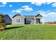 Gray house with a covered patio and grassy backyard at 7171 Rose Hill Ave, Brownsburg, IN 46112
