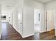 Light and airy hallway with wood-look floors and white doors at 7171 Rose Hill Ave, Brownsburg, IN 46112