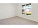 Bright bedroom with neutral carpeting and a large window at 7171 Rose Hill Ave, Brownsburg, IN 46112