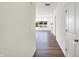 Bright hallway with hardwood floors, offering a view into the living area at 7171 Rose Hill Ave, Brownsburg, IN 46112