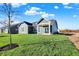 Gray house with a covered patio and well-manicured lawn at 7171 Rose Hill Ave, Brownsburg, IN 46112