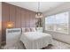 Cozy bedroom with a blush pink accent wall and a comfortable bed at 3577 Idlewind Dr, Westfield, IN 46074