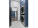 Modern laundry room with stackable washer and dryer, and stylish blue cabinetry at 3577 Idlewind Dr, Westfield, IN 46074