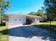 Ranch home with a white garage door and landscaped yard at 7128 Castle Manor Dr, Indianapolis, IN 46214