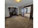 Spacious living room with hardwood floors and double doors at 709 W Riverside Ave, Muncie, IN 47303