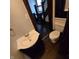 Clean bathroom with toilet, sink, and view of staircase at 709 W Riverside Ave, Muncie, IN 47303