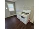Kitchen with white appliances and dark brown floors at 709 W Riverside Ave, Muncie, IN 47303