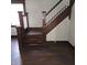 Dark wood staircase with white balusters at 709 W Riverside Ave, Muncie, IN 47303