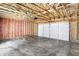 Unfinished garage with concrete floor and overhead door at 3889 Wren Dr, Brownsburg, IN 46112