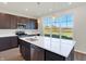 Modern kitchen with island, stainless steel appliances and backyard view at 5870 Fair Oak Cir, Brownsburg, IN 46112