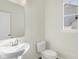 Simple bathroom with white sink, toilet, and mirror at 5870 Fair Oak Cir, Brownsburg, IN 46112