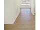 Light-filled entry hall with wood-look floors and view into living area at 7144 Rose Hill Ave, Brownsburg, IN 46112