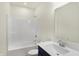 Clean bathroom with white tub/shower and navy vanity at 7144 Rose Hill Ave, Brownsburg, IN 46112