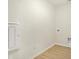 Bright laundry room with vinyl flooring and hookups at 7144 Rose Hill Ave, Brownsburg, IN 46112