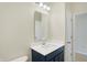 Simple bathroom with navy vanity and a large mirror at 7144 Rose Hill Ave, Brownsburg, IN 46112