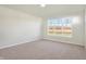 Bedroom with large window and neutral carpeting at 7144 Rose Hill Ave, Brownsburg, IN 46112