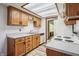 Kitchen boasts wood cabinets, light countertops, and a view to the bathroom at 521 Eagle Crest Dr, Brownsburg, IN 46112