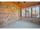 Sunroom with brick walls, window blinds, and ceiling fan at 521 Eagle Crest Dr, Brownsburg, IN 46112