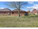 Brick home with a spacious backyard and tree at 521 Eagle Crest Dr, Brownsburg, IN 46112