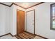 Simple entryway with wood flooring, white walls, and a coat closet at 521 Eagle Crest Dr, Brownsburg, IN 46112