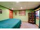 Green basement bedroom with a double bed and Green Bay Packers decor at 6605 Donnelly Dr, Brownsburg, IN 46112