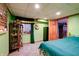 Green basement bedroom with a double bed and display cabinet at 6605 Donnelly Dr, Brownsburg, IN 46112